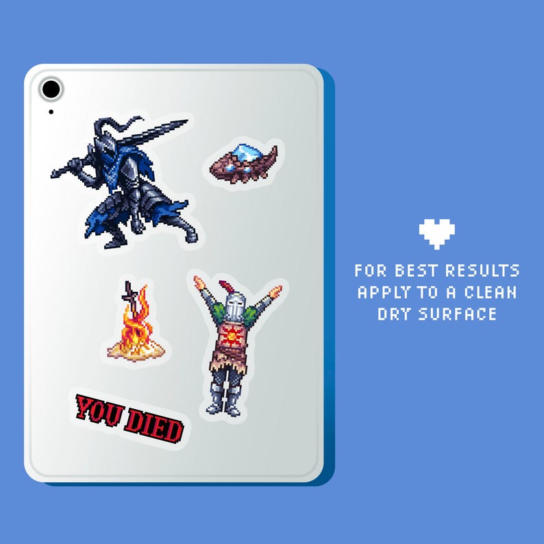 May include: A white tablet with five pixel art stickers. The stickers feature a knight, a bonfire, a knight with a sun symbol, a flying creature, and a red text sticker that says "YOU DIED". The tablet has a white heart in the top right corner and text that says "FOR BEST RESULTS APPLY TO A CLEAN DRY SURFACE".
