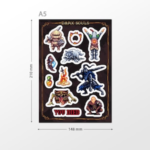 May include: A sheet of Dark Souls themed stickers featuring characters, items, and the iconic "You Died" message. The stickers are printed on a black background with a gold border. The sheet measures 148 mm by 210 mm.