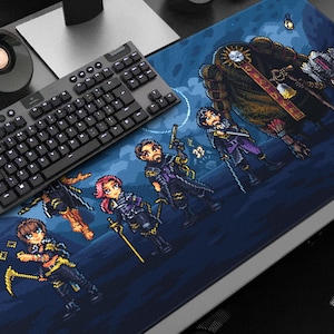 May include: A large, rectangular gaming mousepad featuring a pixelated fantasy scene with several characters in dark clothing. A black keyboard and speaker are on the desk. The mousepad is dark blue with a pixelated design.