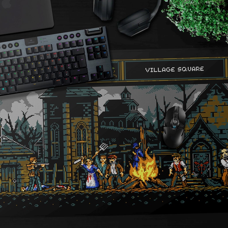 May include: A black and white pixelated design of a village square with a bonfire in the center. The scene depicts a group of people in the village square, with a building in the background. The text "VILLAGE SQUARE" is displayed at the top of the design.