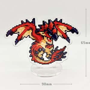 May include: A pixelated dragon figurine with red, orange, and black coloring. The dragon has outstretched wings and is mounted on a clear, circular base. The figurine is 2.5 inches tall and 3.5 inches wide.