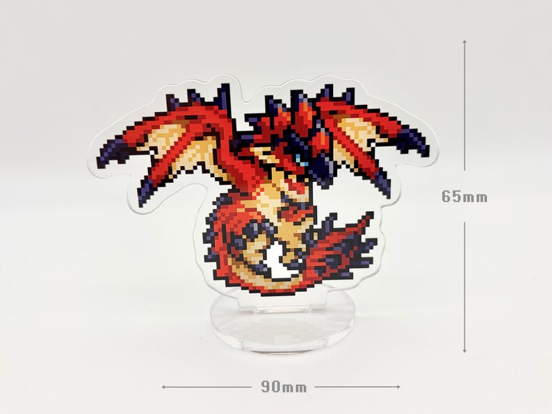 May include: A pixelated dragon figurine with red, orange, and black coloring. The dragon has outstretched wings and is mounted on a clear, circular base. The figurine is 2.5 inches tall and 3.5 inches wide.