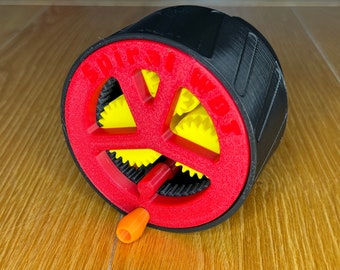 Könnte beinhalten: Ein 3D-gedrucktes mechanisches Gerät mit einem schwarzen zylindrischen Körper, einem roten Rad mit dem Text "SPIRAL WDT" und gelben Zahnrädern. Ein orangefarbener Griff ragt aus dem roten Rad heraus. Zum Mischen von Kaffeepulver.