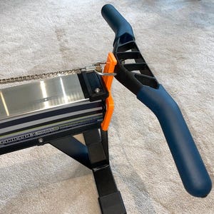 May include: A Concept2 Model D rowing machine, with a navy blue handle and orange details. The machine has a silver rail and a black frame. The text "Concept 2 Model D" is visible on the side.