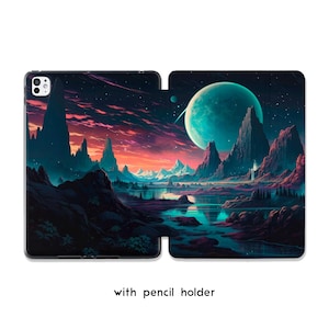 May include: A black tablet case displaying a fantasy landscape with a teal planet, mountains, and a lake under a colourful sky. The case has a pencil holder. Text on the case reads: with pencil holder.