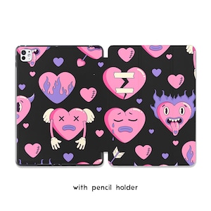 May include: Black iPad case with a repeating pattern of pink and purple cartoon hearts with various expressions. Some hearts have flames, tears, or stitches. The case includes a pencil holder.