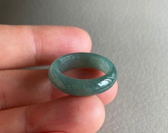 May include: A green jade ring with a smooth, polished finish.