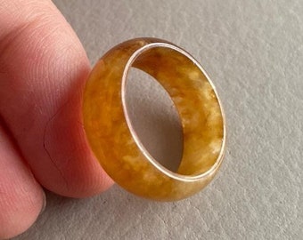 May include: A yellow resin ring with a marbled pattern.