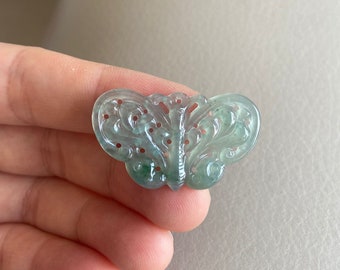 May include: A delicate green jade butterfly pendant with intricate carvings and a translucent finish.