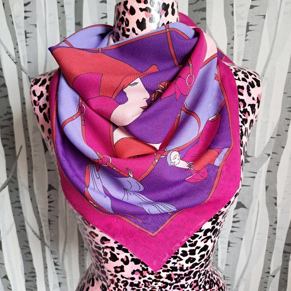 A delightful pink and purple scarf with an art deco style design. 1970s vintage neckscarf with a fun 1920s ladies pattern.