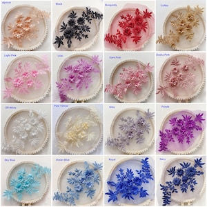 May include: Assortment of 16 floral lace appliques in various colors, including apricot, black, burgundy, coffee, light pink, lilac, dusky pink, dark pink, pale yellow, off white, grey, purple, sky blue, ocean blue, royal blue, and navy blue. Each applique features a delicate floral design with leaves and flowers.