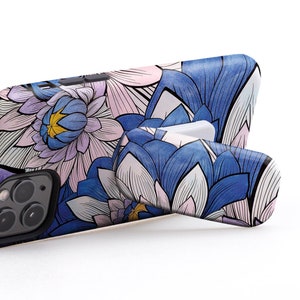 May include: A phone case with a floral design in shades of blue, pink, and white. The case has a built-in kickstand that can be used to prop up the phone in landscape mode. "Use it in landscape mode to watch videos" is written in black text on a white background.