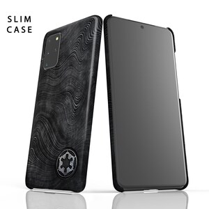May include: A black phone case with a wavy pattern and a silver Imperial symbol. The case is designed for a slim fit and has a black screen protector.