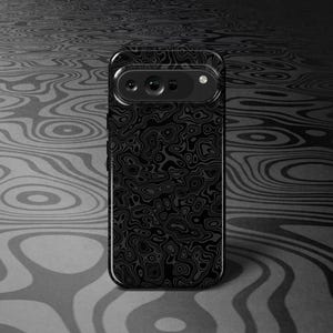 May include: A black smartphone case with a unique, swirling pattern. The case has a camera module at the top and a sleek, modern design. The background features a similar pattern in shades of gray.