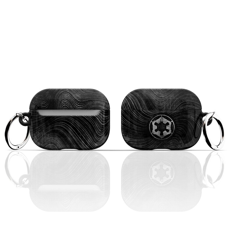 May include: Black and white patterned Airpods case with a silver keychain and a silver Imperial symbol on the front.