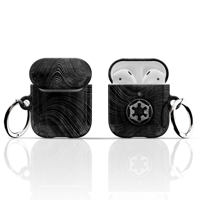 May include: Black and white patterned AirPod case with a silver key chain and the Imperial symbol from Star Wars.