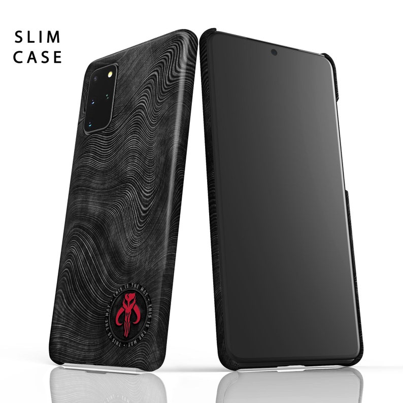 May include: A black phone case with a wavy pattern and a red Mandalorian symbol with the text "This is the way" around it. The case is designed for a slim fit.
