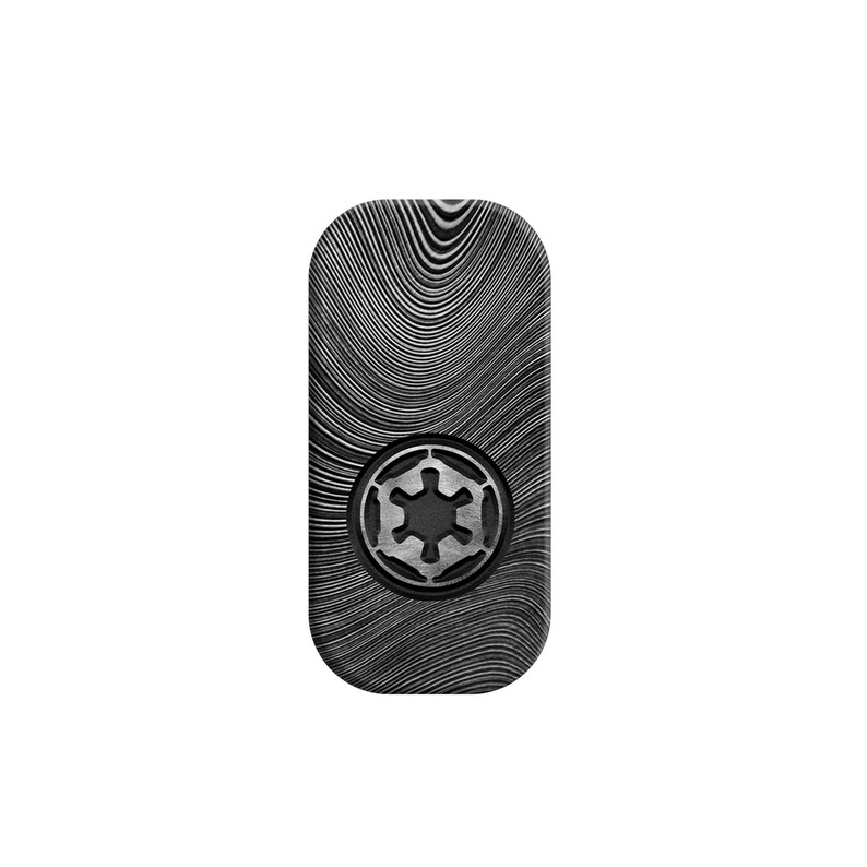 May include: A rectangular, textured, black and silver money clip with rounded corners. The clip features a circular emblem in the center, and a swirling pattern across the surface. The emblem is a six-pointed star within a circle.