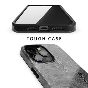 May include: A black phone case with a white and gray wavy pattern. The case has a raised camera bump and a cutout for the phone's charging port. The text "TOUGH CASE" is printed on the case.
