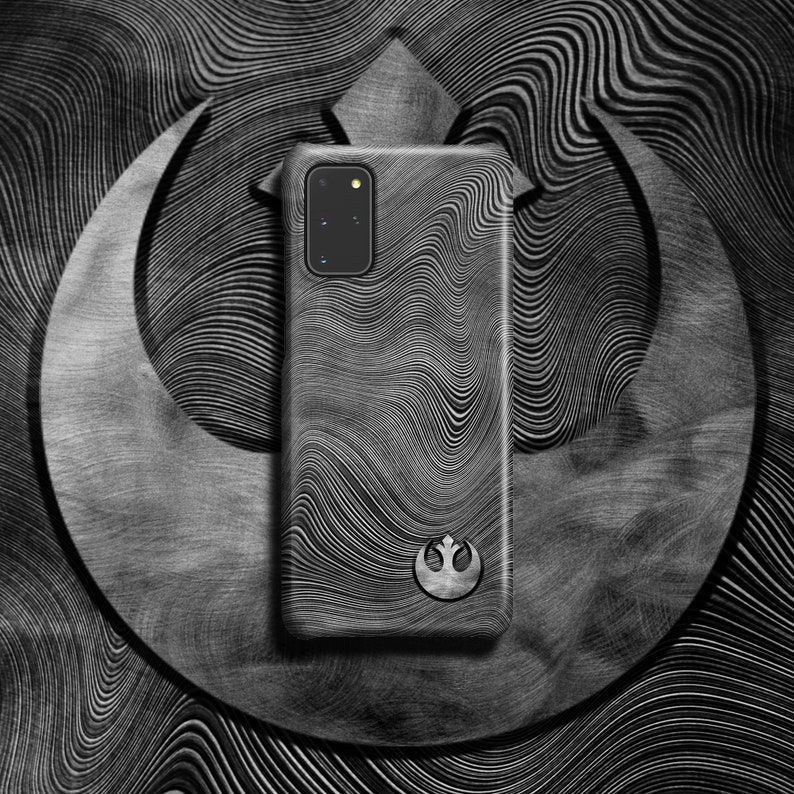 May include: A black phone case with a Rebel Alliance symbol and a wavy, abstract pattern. The case is designed for a Samsung Galaxy S20.