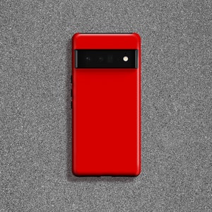 May include: A red phone case with a black camera lens cutout.