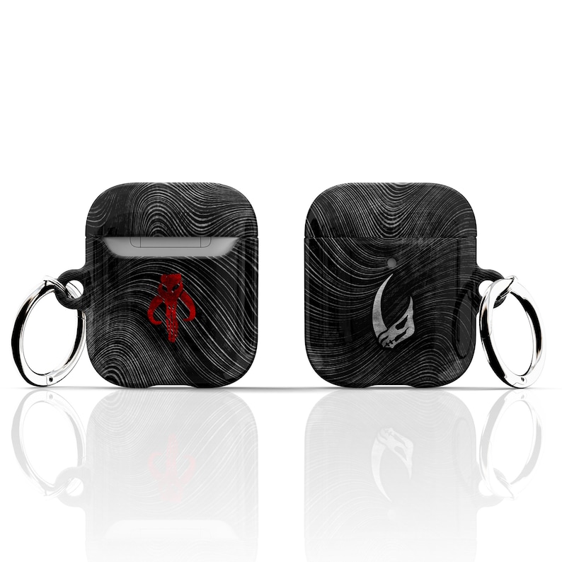 May include: Two black Airpod cases featuring a Mandalorian and a Boba Fett design. Each case has a silver ring attached to the top.