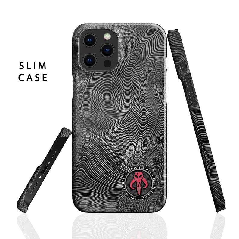 May include: A black and white slim phone case with a wavy pattern. The case has a red and black Mandalorian symbol with the text "This is the way" around it.