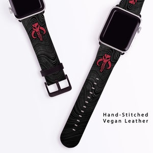 May include: Two black and white patterned Apple Watch bands with a red Mandalorian symbol. The bands are made of vegan leather and are hand-stitched. "Hand-Stitched Vegan Leather" is written in white text on a white background.