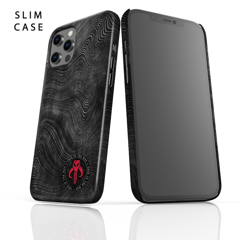 May include: A black and grey phone case with a wavy pattern and a red Mandalorian symbol. The text "This is the way" is printed around the symbol. The case is designed for a slim fit.