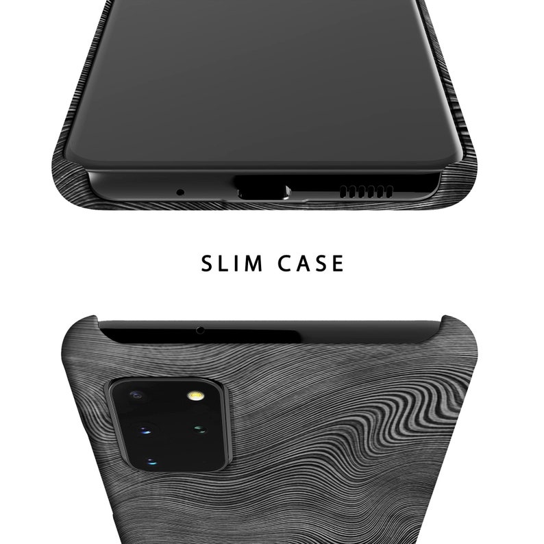 May include: A black phone case with a wood grain pattern. The case is designed to fit a phone with a camera bump on the back. The text "SLIM CASE" is printed on the case.
