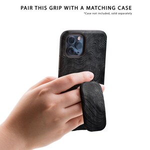 May include: A black phone case with a wavy pattern and a black phone grip with a wavy pattern.  *Case not included, sold separately.