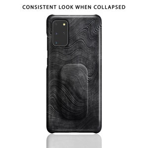 May include: Black phone case with a wavy pattern and a black accent on the back.