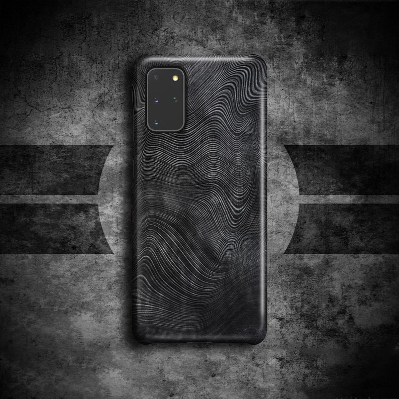May include: A black phone case with a wavy, abstract pattern. The case has a camera lens cutout in the upper left corner.