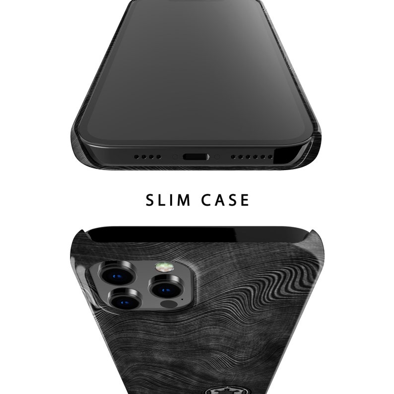 May include: A black phone case with a wood grain pattern. The case has a raised camera bump and a cutout for the phone's charging port. The text "SLIM CASE" is printed on the case.