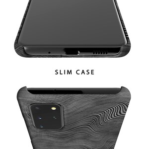 May include: A black phone case with a wood grain pattern. The case is designed to fit a slim phone and has a raised camera bump.