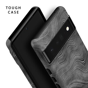 May include: A black phone case with a textured, wavy pattern in shades of gray. The case has a cutout for the camera lens and a "TOUGH CASE" label.