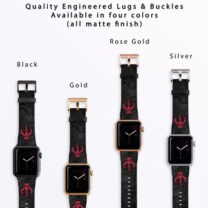 May include: Four Apple Watch bands with different colored metal clasps: black, gold, rose gold, and silver. Each band has a black and white patterned design with a red Mandalorian symbol.