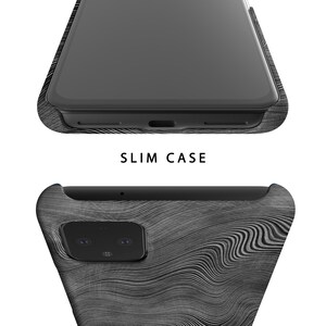May include: A black phone case with a wood grain pattern. The case is designed to fit a phone with a camera bump.