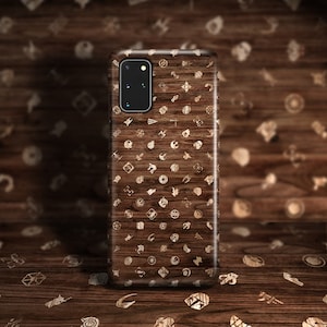 May include: A brown wood phone case with a pattern of small white icons. The icons are various shapes and sizes, and they are all related to the Star Wars franchise.