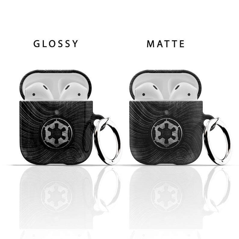 May include: Two black AirPod cases with a white Imperial symbol and a silver key chain. One case is glossy and the other is matte.