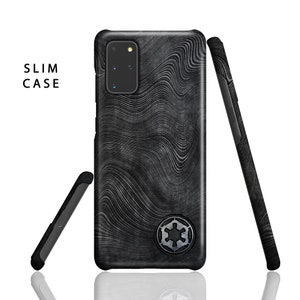 May include: A black phone case with a grey and white wavy pattern and a black and silver symbol. The case is designed to fit a Samsung Galaxy S20 Ultra phone. The case is labelled "SLIM CASE".