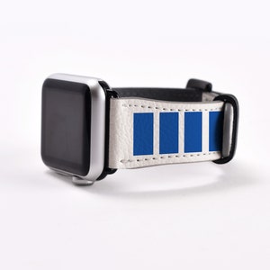 May include: White leather Apple Watch band with a blue stripe design. The band is compatible with Apple Watch Series 4 and later.