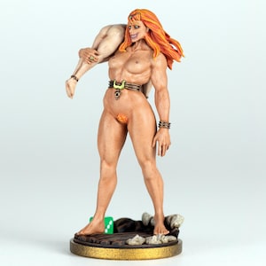 May include: A nude figurine of a muscular woman with orange hair, holding a smaller figure. The woman wears a belt and bracelets. The base is gold with a wooden platform and rocks. A green die is visible.