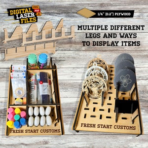 Puede incluir: Un expositor de madera cortado con láser con múltiples patas y formas de exhibir artículos. El expositor está hecho de madera contrachapada de 6,35 mm de grosor y tiene el texto "FRESH START CUSTOMS".