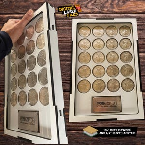 May include: A white display case with a black border, designed to hold 20 coins. The case is made of 1/4 inch plywood and 1/4 inch acrylic. The case has a small rectangular space at the bottom for a label or inscription. The text "DIGITAL LASER FILES" is printed in red and black on a white background.
