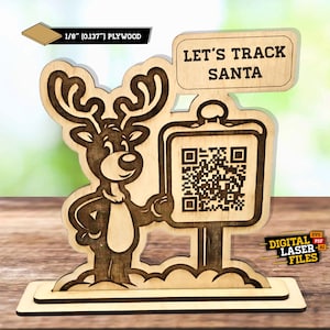 May include: A wooden reindeer figurine holding a sign with a QR code and the text "Let's Track Santa". The sign is attached to a wooden post. The reindeer is standing on a cloud-shaped base. The base is attached to a larger rectangular base. The image is labeled "1/8" (0.137") Plywood" and "Digital Laser Files".