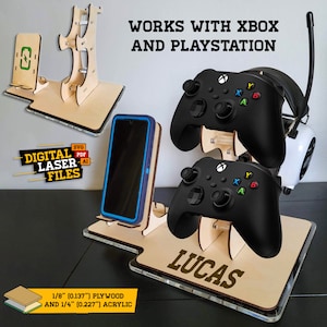 Puede incluir: Un soporte de madera cortado con láser para un mando de consola de juegos, auriculares y teléfono. El soporte está hecho de madera contrachapada de 1/8 de pulgada y acrílico de 1/4 de pulgada. El soporte está personalizado con el nombre "Lucas".