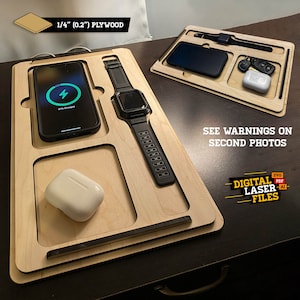 May include: A wooden charging station with slots for a phone, watch, and wireless earbuds. The phone is charging and the watch is black. The station is made of 1/4 inch plywood. "See warnings on second photos" and "Digital Laser Files" are printed on the station.