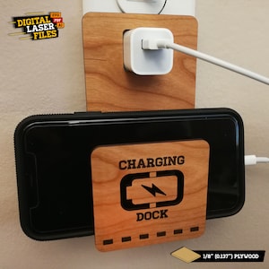 May include: A wooden phone charging dock with the text "CHARGING DOCK" and a lightning bolt icon. The dock is mounted on a wall and has a phone charging cable plugged into it. The dock is made of 1/8" (0.137") plywood.