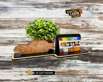 May include: Wooden car and business card holder with a black and brown base. The holder features a wooden car cutout and a slot for business cards. The text "DIGITAL LASER FILES" is visible. Made from 1/8" (0.137") plywood.